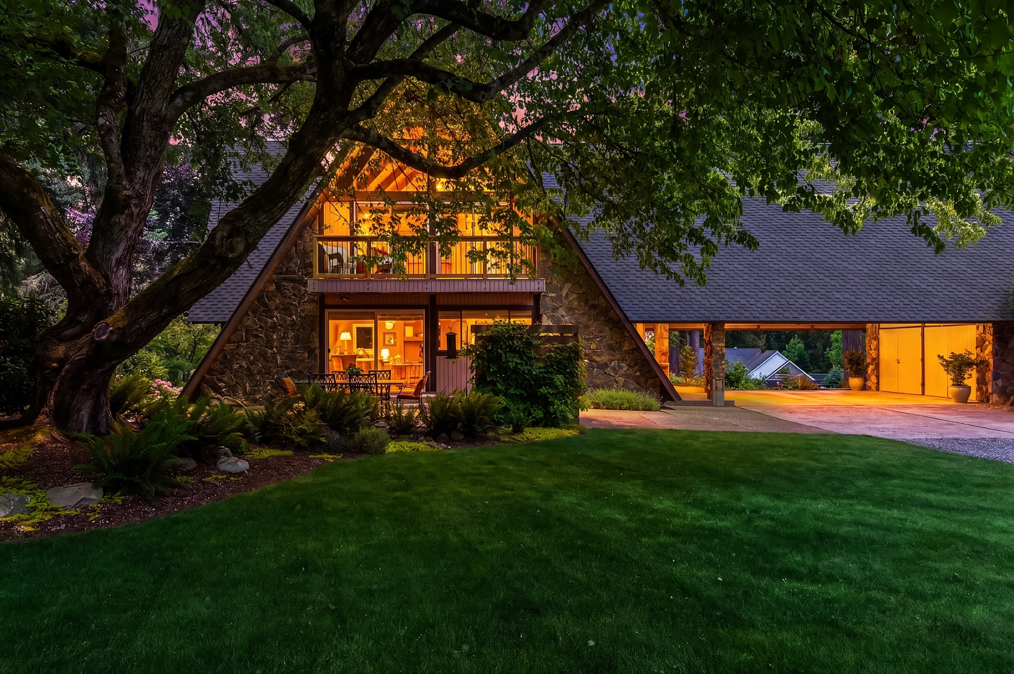 Front entry and lit carport at twilight