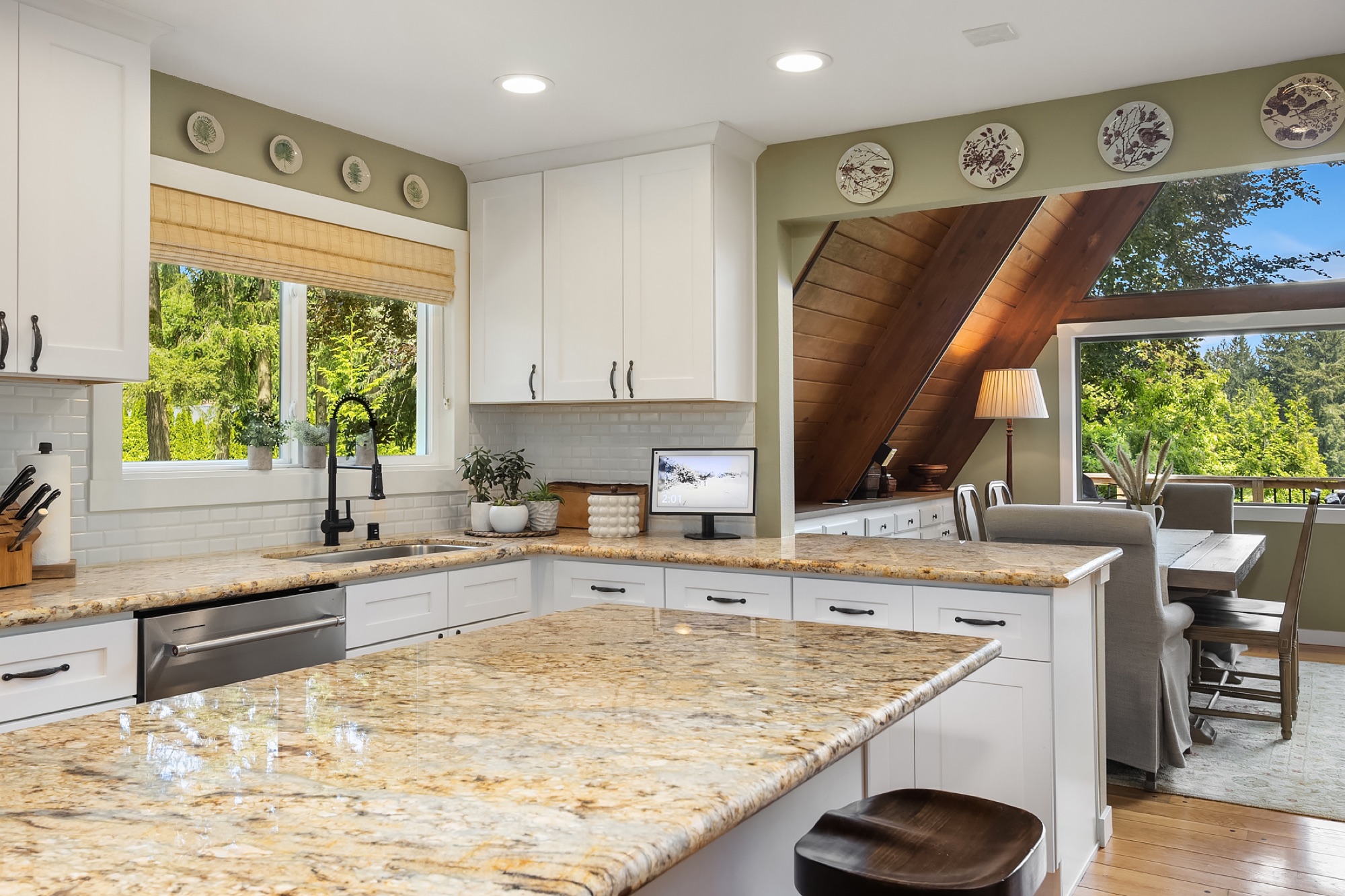 Kitchen with granite counters and A-frame ceiling visible